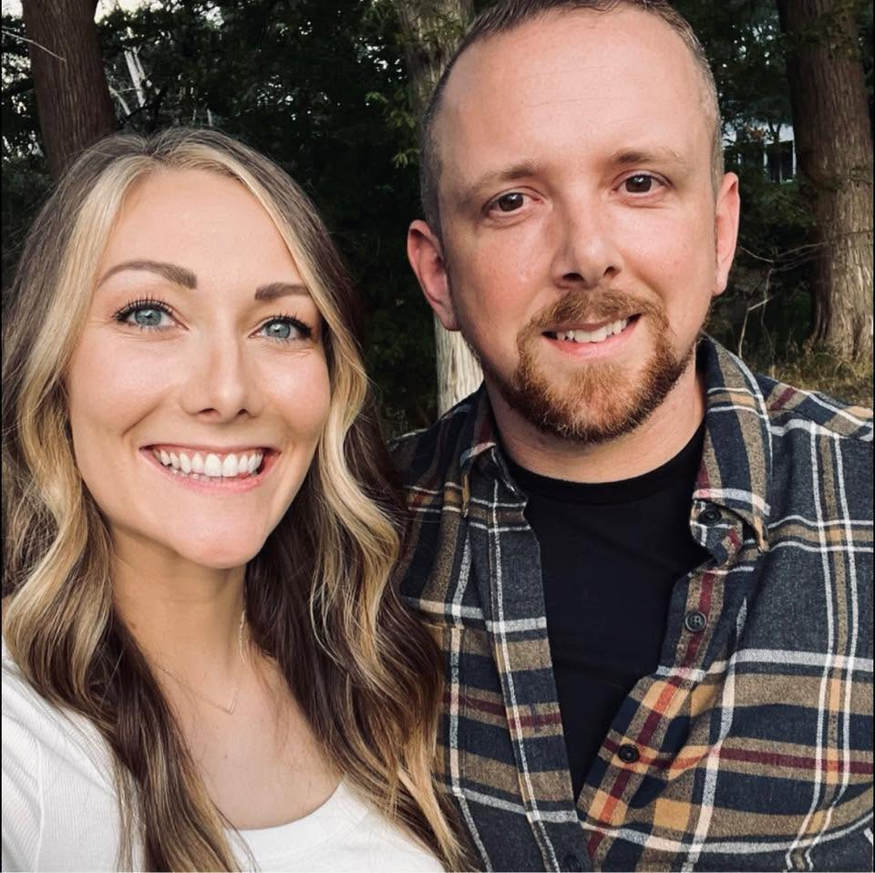 Jesse and his wife smiling outdoors