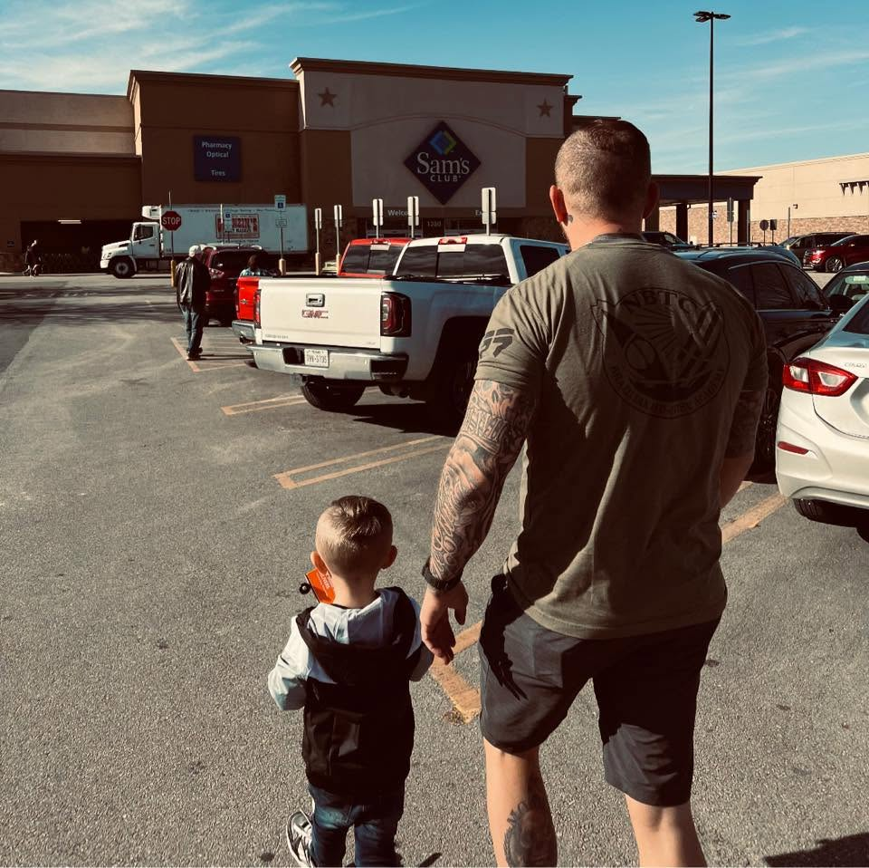 Jesse walking hand in hand with his son